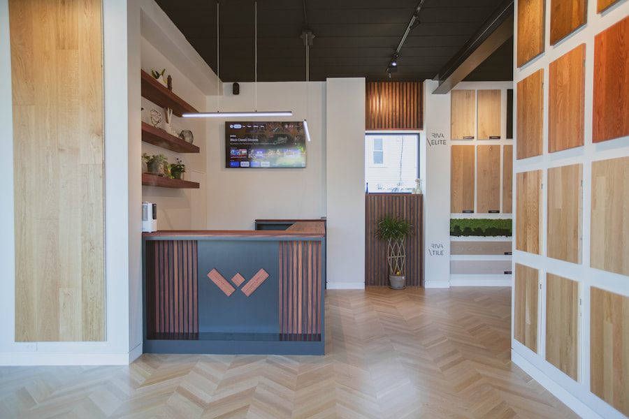 Interior view of a Weles's showroom, featuring various wood panels and a reception desk.